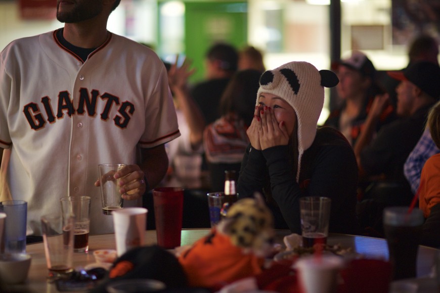 Stephanie Choy (right) reacts to a Kansas City Royals hit during the early stages of Game 6. (Spenser Linney/Peninsula Press)