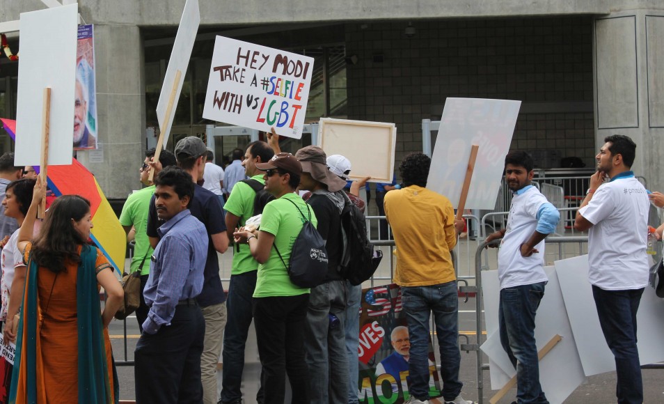 A protester holds up a banner in solidarity with the LGBT community, outside the San Jose, California, where India Prime Minister Narendra Modi addressed the Indian diaspora on September 27, 2015. The placard protests against a law in India that criminalizes homosexuality. (Saurabh Datar/Peninsula Press)