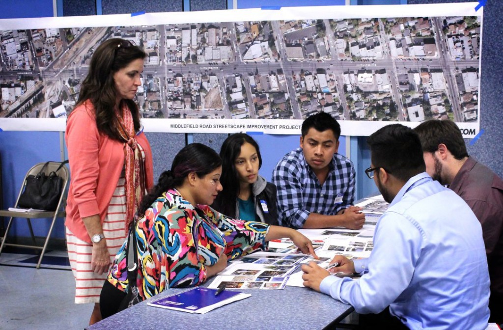 Community members and consultant Millette Litzinger, left, discuss plans for a redesigned Middlefield Road at a design workshop in North Fair Oaks, Calif. on Sept. 30, 2015. As they weighed wider sidewalks against extra parking, many residents were more concerned that a nicer street would spur gentrification. (Jeff Barrera/Peninsula Press)