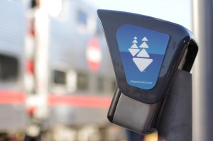 A Caltrain passes by a Clipper card reader at the Palo Alto Transit Center on October 20, 2015. Caltrain is considering increasing fares and parking fees. (Jeff Barrera/Peninsula Press)