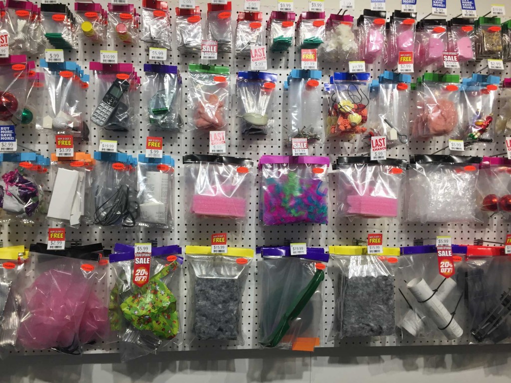 Student artist Jinmei Chi filled a pegboard with plastic packages full of objects she found during her Recology Residency, in her installation "Dizz Mall". (Dylan Anslow/Peninsula Press)