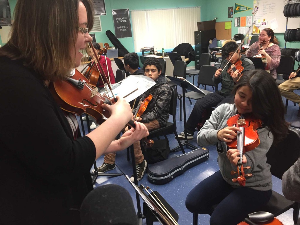 Orchestra teacher Sarah Azevedo leads a group of eighth-graders through scales practice. Orchestra is a new class at Cesar Chavez Academy, made possible by California’s new school financing model. (Ashley Gross/Peninsula Press)