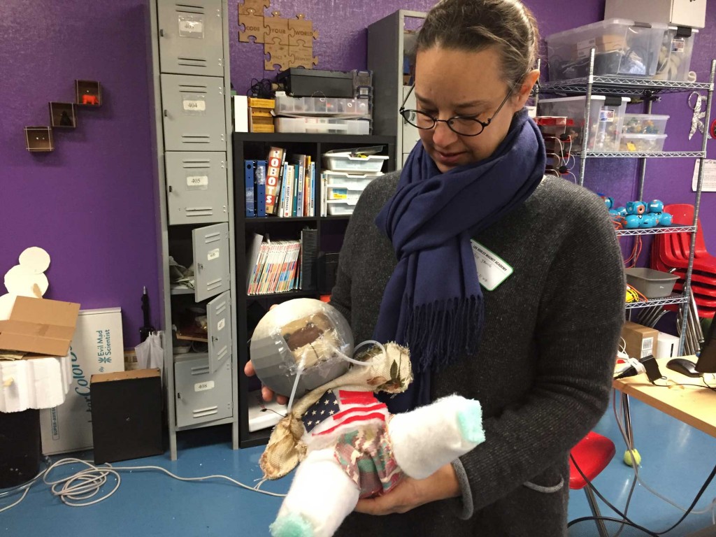 Nico Janik oversees the Ravenswood district’s “makerspaces,” where kids can build robots, use 3D printers and create spacesuit prototypes, such as this one. (Ashley Gross/Peninsula Press)