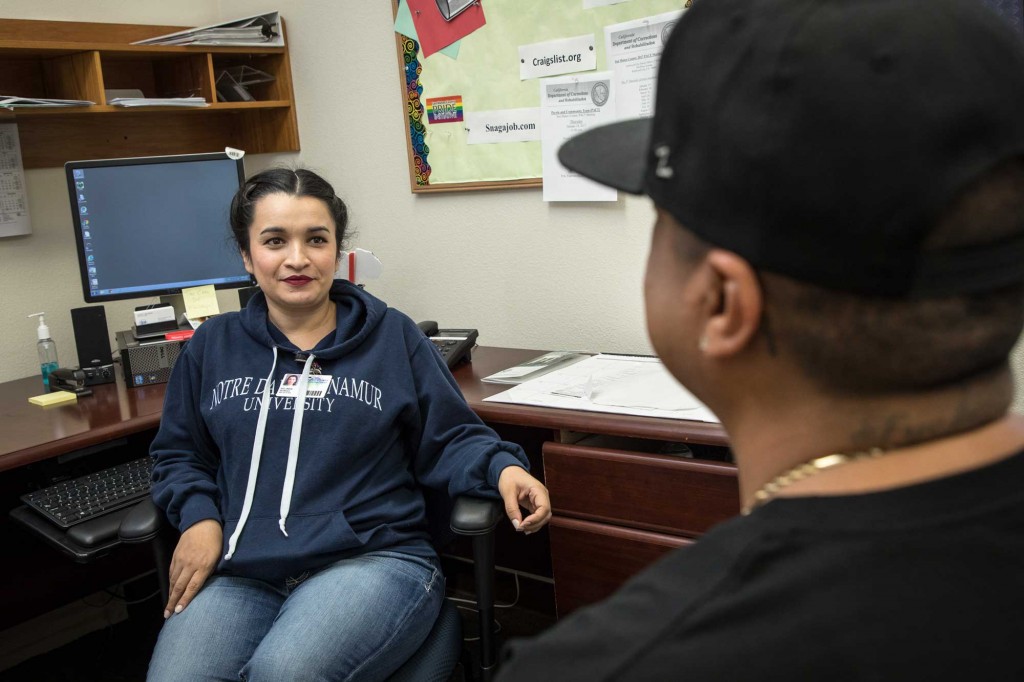 Belinda Borgo, mental health intern, speaks with Jose Cabrera, community worker at the David E. Lewis Community Reentry Center in East Palo Alto. (Photo courtesy of Preston Merchant/San Mateo County Health System)