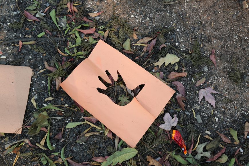 Though Paradise Elementary School’s buildings were destroyed by Camp Fire, the blaze spared patches of the school yard, leaving candy wrappers and art projects, like this cutout of a child’s hand.  Isabella Jibilian/Peninsula Press