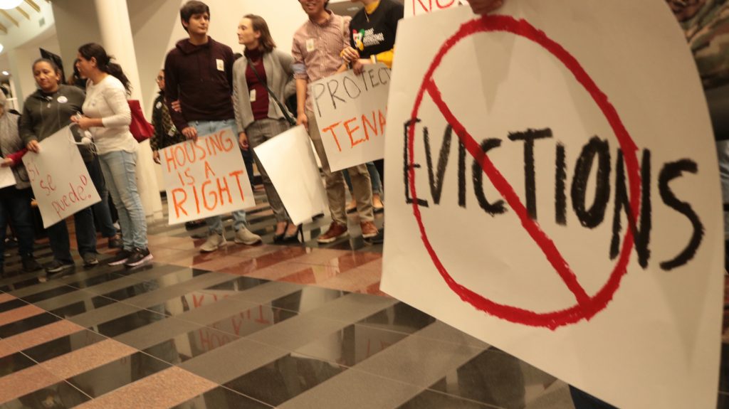 Tenants, faith leaders and tenants rights advocates gather in city hall in Redwood City, Calif.