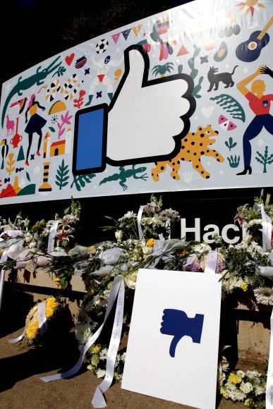 After the protest, a thumbs-down sign, along with memorial flowers, was left in front of Facebook’s iconic thumbs-up “like” sign at the entrance of the company’s Menlo Park campus on Thursday September 26, 2019. Protestors say they are not happy with the company’s silence towards Qin Chen’s suicide case. 