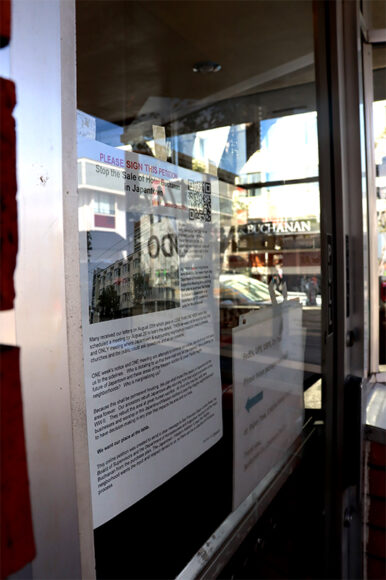 A petition to stop the sale of the Kimpton Buchanan Hotel hangs on the door of the Benkyodo Co. bakery across the street from the hotel in San Francisco's Japantown on Sep. 26, 2021. (Natasha Jessen-Petersen/Peninsula Press)