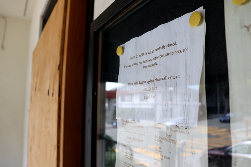 A weathered “currently closed” sign hangs in the window of Restaurant Mums, the restaurant attached to the Kimpton Buchanan Hotel in Japantown on Sep. 26, 2021. (Natasha Maki Jessen-Petersen/Peninsula Press)