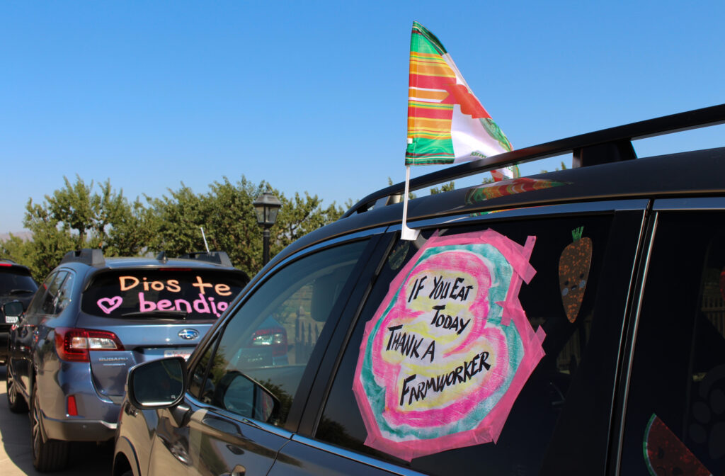 A vehicle is decorated with a sign that says, "If you eat today, thank a farmworker."