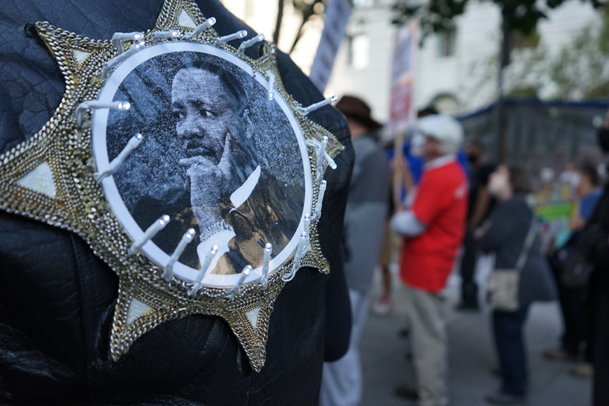 A protester wears a Martin Luther King jacket during a rally in San Francisco, Friday, Sept. 24, 2021. The protester was part of a march against the treatment of Haitian refugees at the Texas border, which led about 50 individuals to walk from the city’s Federal Building to UN Plaza. (Elissa Miolene/Peninsula Press) 