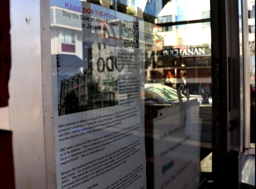 A closeup of a sign taped on the window of a bakery.