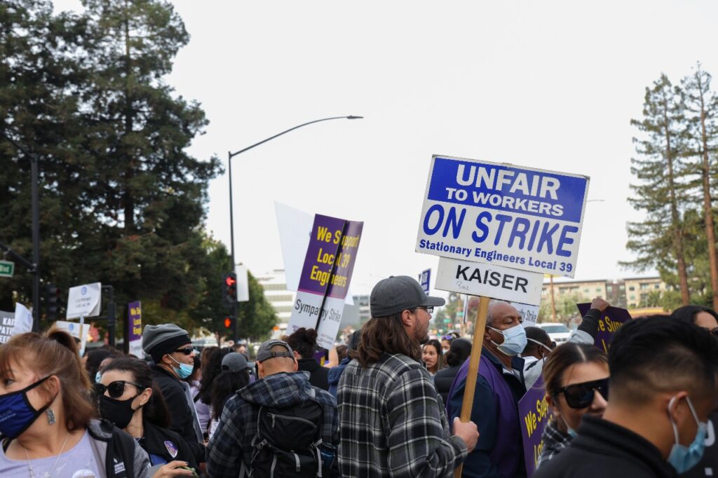 A crowd with some people holding up signs.