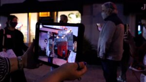 A close-up of someone holding up a tablet.