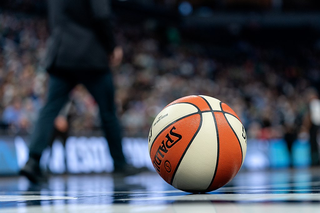 A closeup of a basketball on the court.