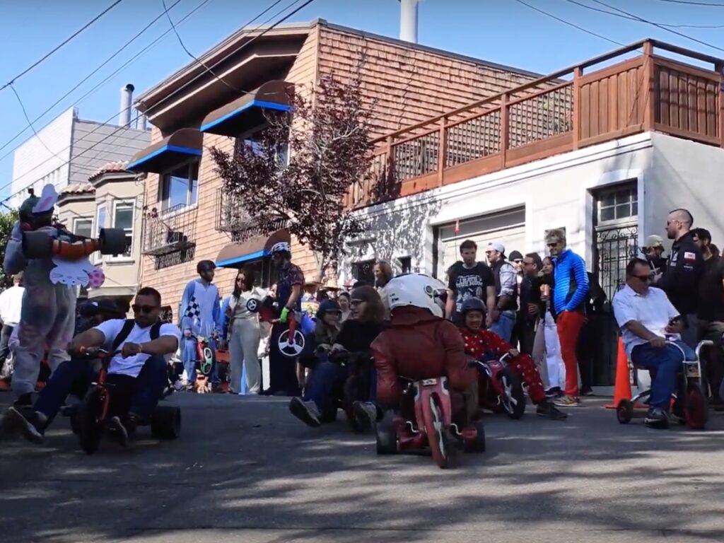 Adults start a tricycle race.
