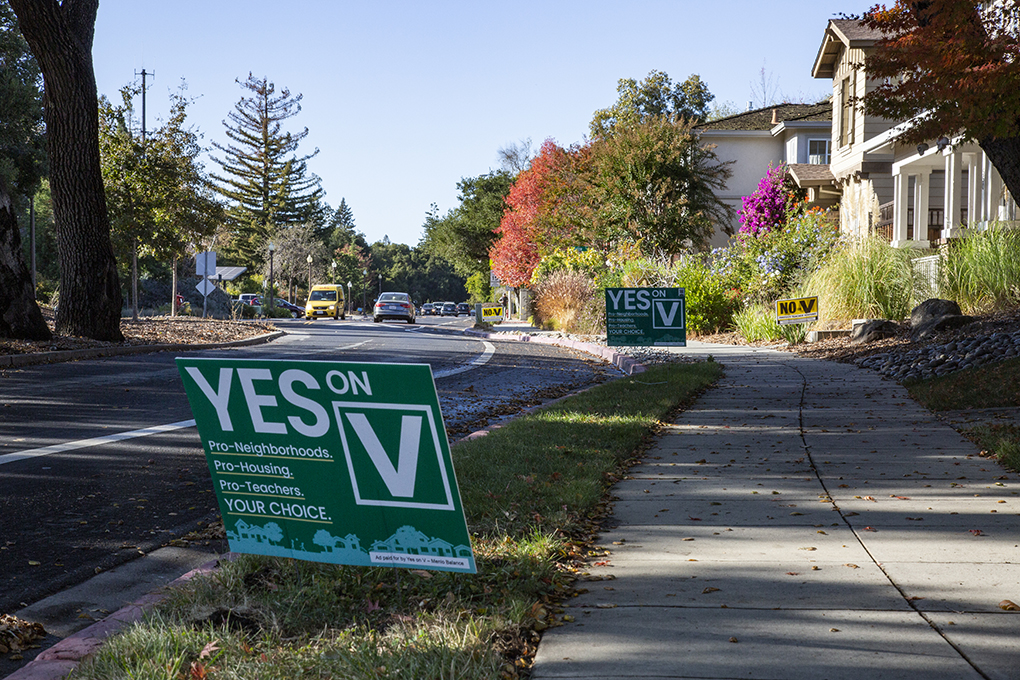 In front yards across Menlo Park, green “Yes on V” campaign signs