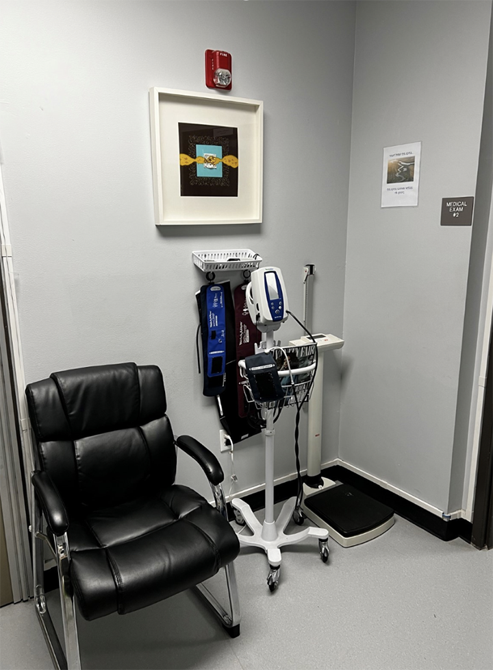 Peninsula Healthcare Connection clinic waiting room, with chair and vitals machinery.