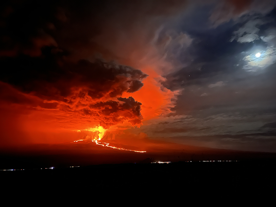 : Below a red sky, thousands of cars on Saddle Road come from both sides of the Island