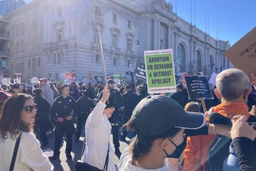 A crowd of protesters in front of San Francisco City Hall.