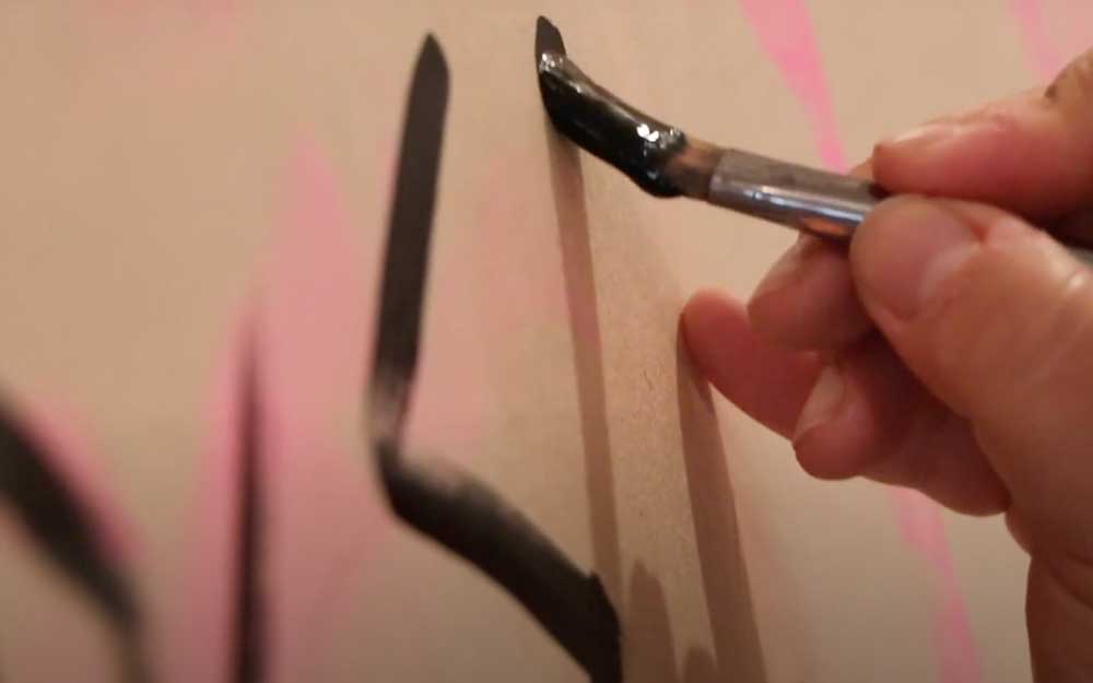 Closeup of a hand painting with a paintbrush