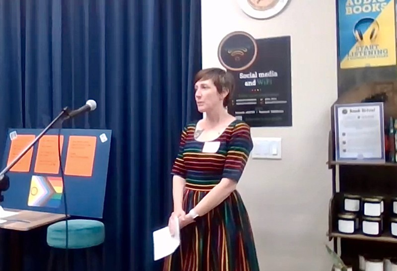 A woman speaks in front of a microphone.