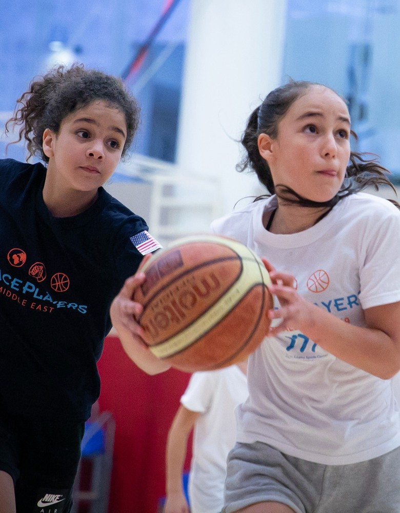 klavon_photo One player is holding a basketball another is right behind her.
