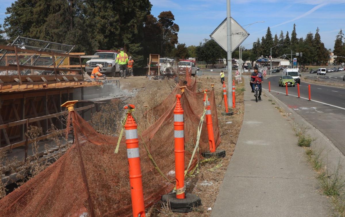 Sidewalk by pedestrian bridge construction