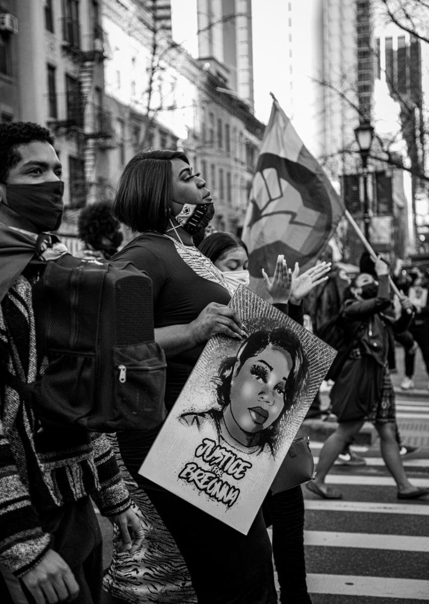 Side profile photo of Qween Andy Jean holding a 'Justice for Breonna Taylor' poster.