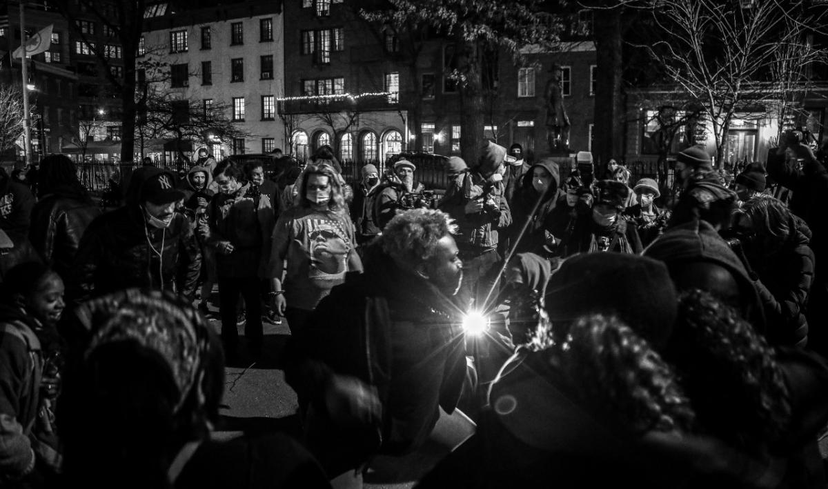 A group of protesters stand in a circle.